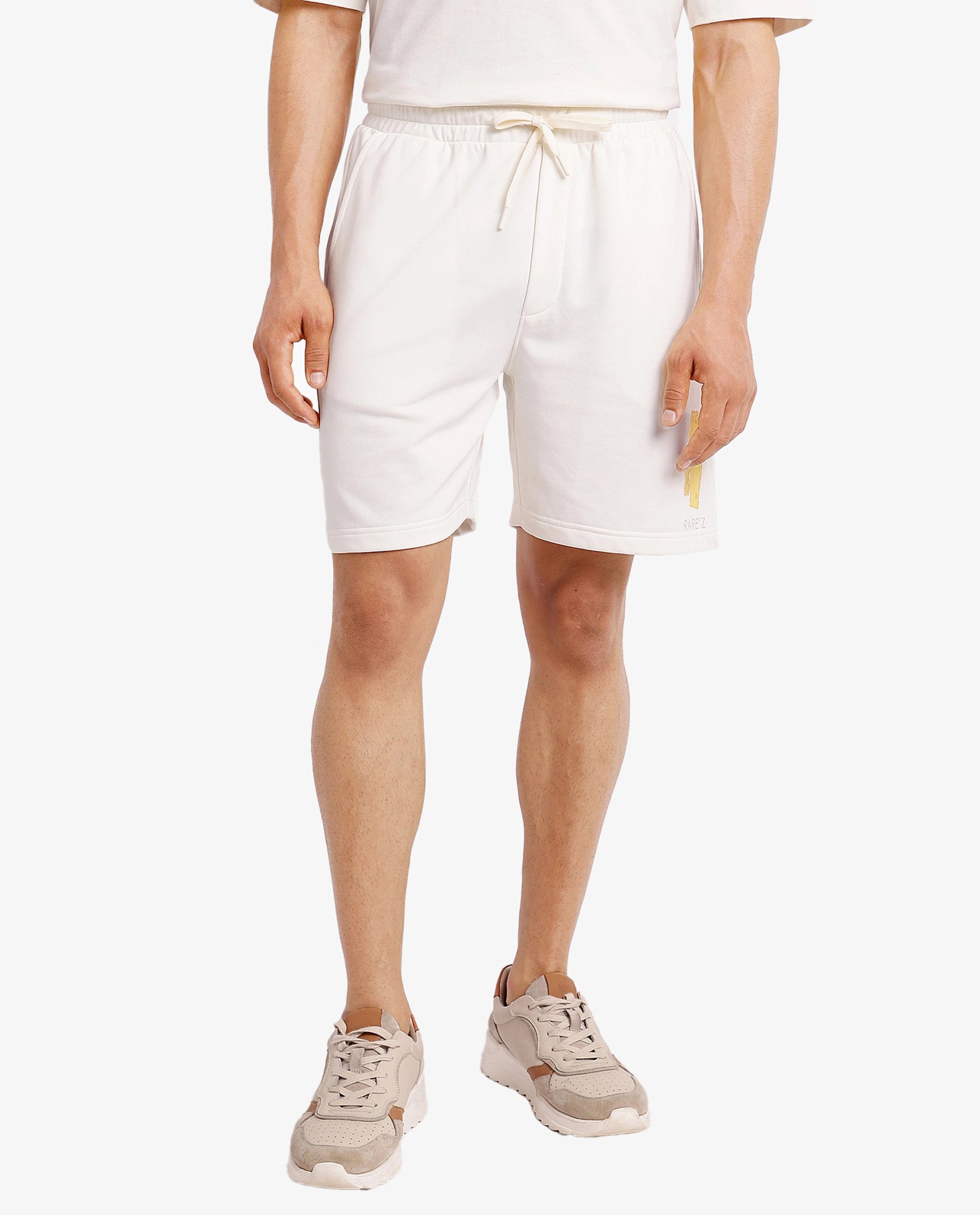 Men's Pants with Contrast Fabric PanelsRare Rabbit Men Jadez-B Off White Cotton Fabric Placement Print Drawstring Closure Oversized Fit Shorts